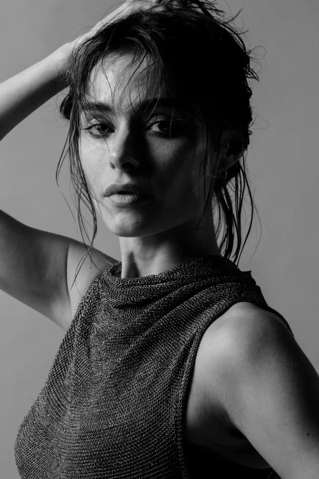 livvy in a blue outfit holding a camera